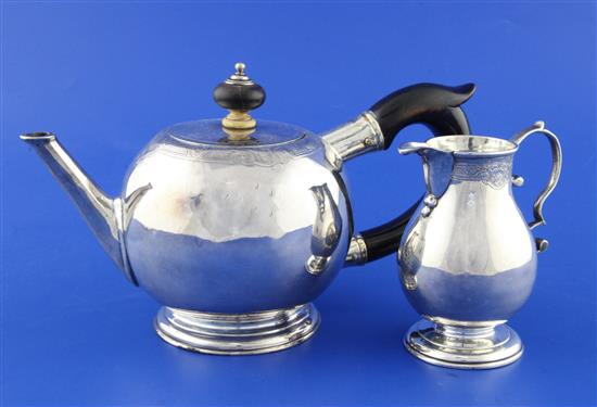 A George I silver bullet shaped teapot and matching cream jug by John Swift, gross 16 ozs.